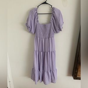 Dressed in LALA purple tiered dress, size medium.
